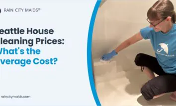 Rain City Maids cleaner in branded uniform cleaning a shower in a Seattle home