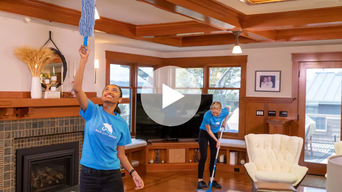 Rain City Maids cleaners dusting and mopping a living room
